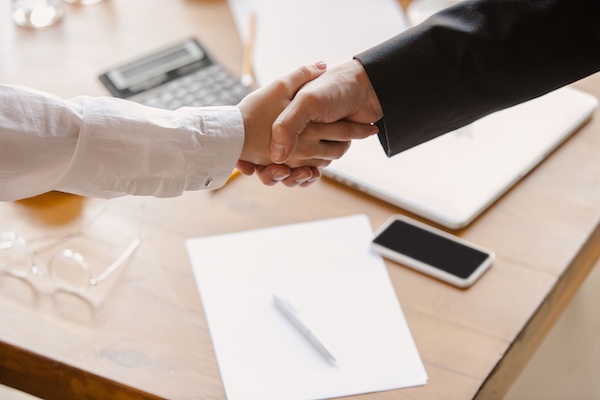 Professionals negotiating an agreement across a conference table